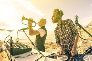 Groupe de musique electro avec DJ hip hop et trompettiste lors d un concert rap sur une plage