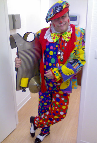 Un clown musicien tres colore avec son washboard a la main