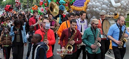 La fanfare ouvre le cortege d'un defile de carnaval avec plein de ballons colores