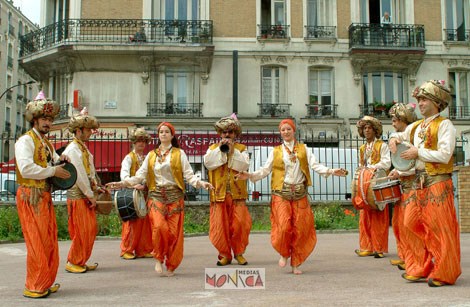 Les musiciens entourent les danseuses en jouant des musiques orientales