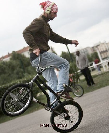 Le freestyler effectue des figures au sol en faisant tourner son velo bmx